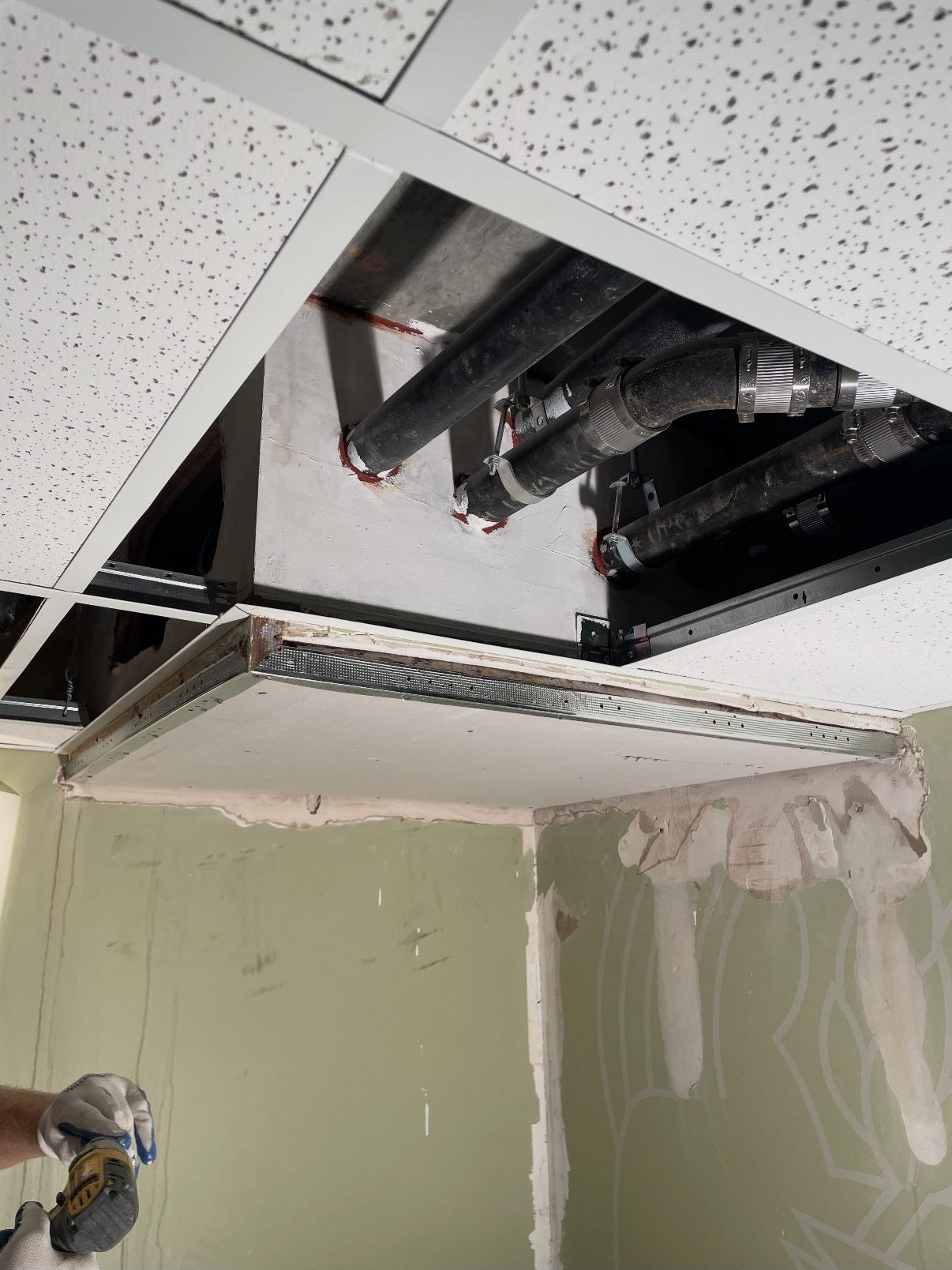 New ceiling panel installed after leak and dry-rot repair